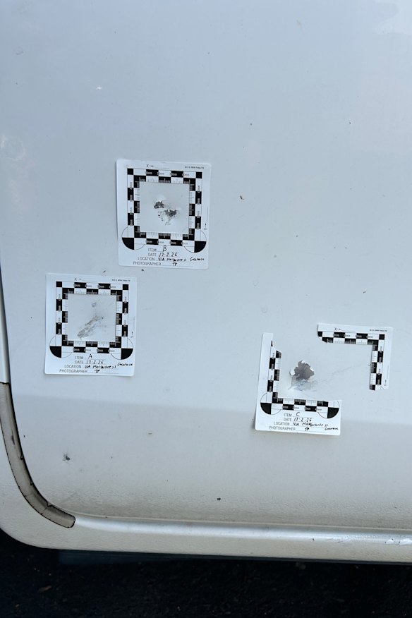 Bullets in the door of a Hilux ute outside the home showing bullet grazes.