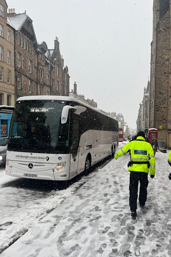 The Wallabies team bus parked on the Royal Mile in Edinburgh, with snow falling.