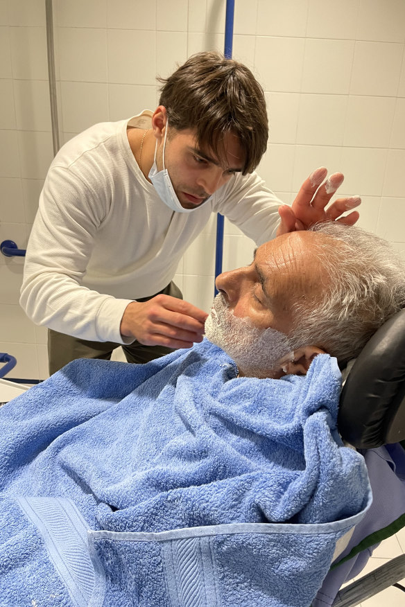 One of Kureishi’s sons, Sachin, shaving his father’s face.