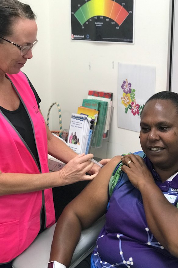 Nurse Ruth Ferguson vaccinates Saibai Island school teacher Norah Tabuai. 