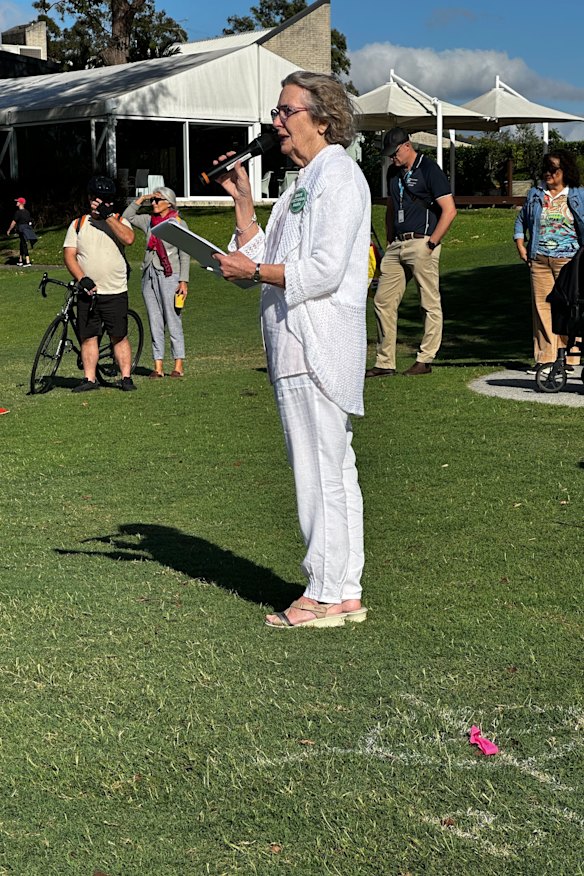 Sue Bremner speaking beside a GIICA bore marker.