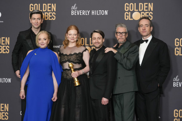 Succession stars Nicholas Braun, J. Smith-Cameron, Sarah Snook, Kieran Culkin, Alan Ruck and Matthew Macfayden with the Golden Globe that Succession won for best television series.