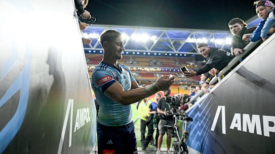 Zac Lomax poses with fans after the first State of Origin, 2025