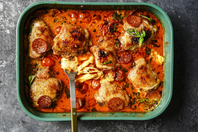 Tip: Instead of a roasting tray (pictured), use an ovenproof frypan to turn this pizza-inspired chicken bake into a one-pan wonder.