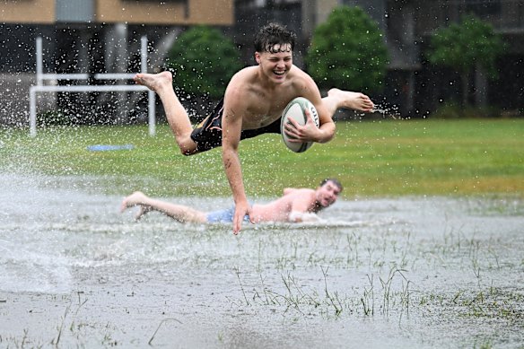 Boys make the most of a flooded park in Rosalie,