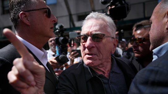 Robert De Niro, center, argues with a Trump supporter after speaking to reporters in support of Joe Biden