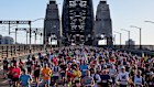 Crowds stream across the bridge for the Sydney marathon.
