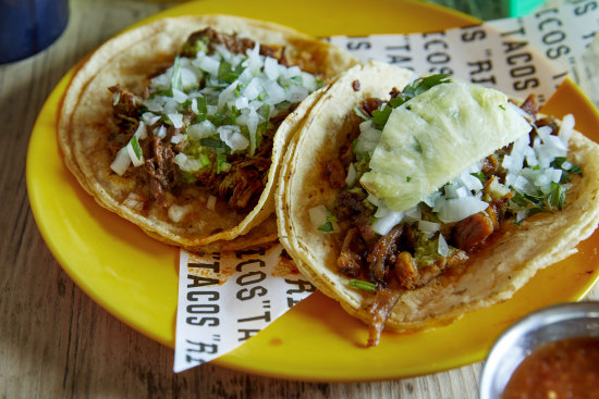 Chipotle barbacoa beef taco (left) and al pastor pork and pineapple taco.