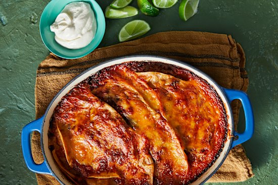 Tortillas, spices and bubbling cheese turn vegie-loaded bolognese sauce into this Mexi-spice tray bake.