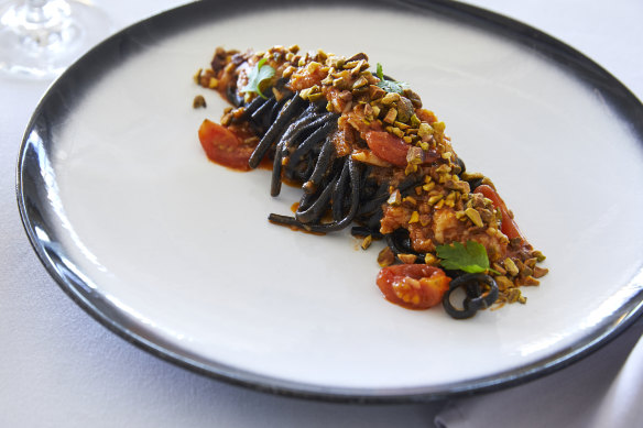 Squid ink linguine with crab, cherry tomato and pistachio.