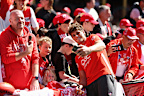 Sydney superstar Charlie Curnow takes a photo with Swans fans.