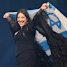 FILE - Singer Yuval Raphael, from Israel, holds the national flag during a dress rehearsal for the Grand Final of the 69th Eurovision Song Contest, May 16, 2025, in Basel, Switzerland. (AP Photo/Martin Meissner, File)