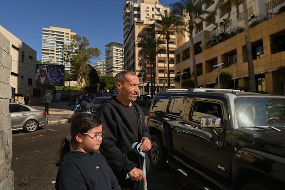 Ahmad Sweidan and granddaughter Fatima Sweidan outside the Ramada Plaza Hotel, which was hit in an Israeli airstrike.
