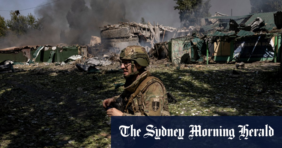 Ukrainian troops battle to hold key town as Moscow says pincer closing