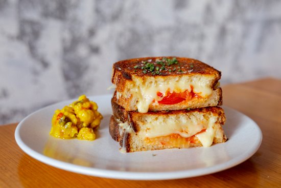 Three-cheese toastie with warrigal greens, kimchi and tomato.