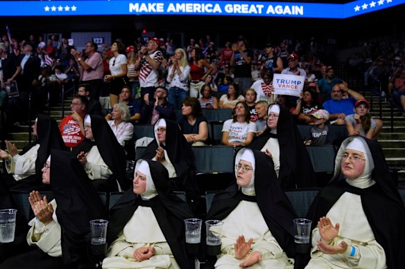 People listen as Republican presidential candidate former President Donald Trump speaks at a campaign rally in Grand Rapids, Michigan, USA.