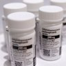 Bottles of Merck & Co. and Ridgeback Biotherapeutics’s Molnupiravir antiviral medication arranged in a warehouse.