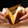 The circular pastries are filled with custard, which changes flavour each month.