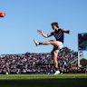 Jye Amiss of the Dockers kicks the ball.