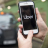 An ongoing battle: A commuter uses Uber in view of a line of black cabs in London, UK.