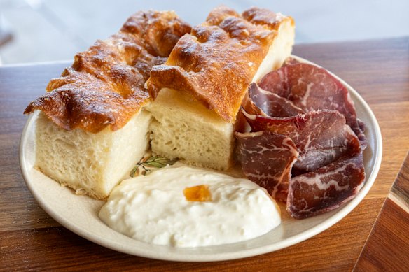 Fresh focaccia with stracciatella, bresaola and hot honey at Gracie’s Wine Room.