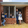 Zoe-Marie and Joel Masters with their children Temperance (12), Max (10), Grace (4) and Lilly (2) outside their unfinished home in Mandogalup.