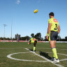 Umpires practice the art of the centre bounce.