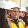 Premier Jacinta Allan, centre, at a building site for the Suburban Rail Loop.