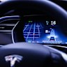 An instrument panel illustrates the road ahead using Tesla Autopilot technology .