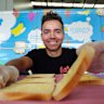Lydon Galea makes cheese sandwiches for kids who might go hungry in school.