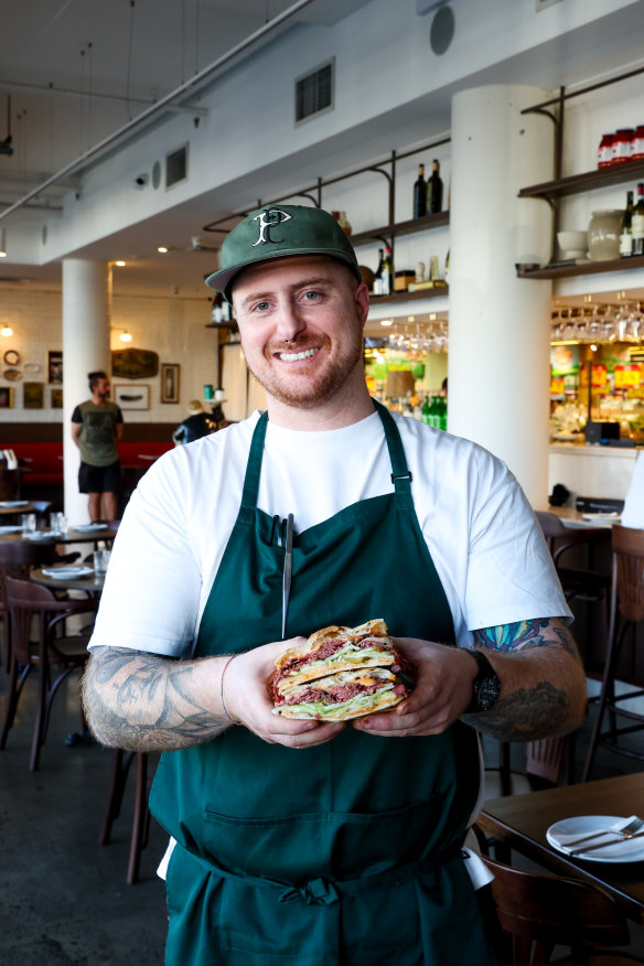 Co-owner Stefano De Caro with his sandwich. 