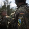 A patch with a coat of arms combining the NATO insignia and that of the German federal state of Saxony is seen on a soldier’s uniform as troops of Dutch and German units take part in military exercises near Gardelegen, Germany, on Wednesday.