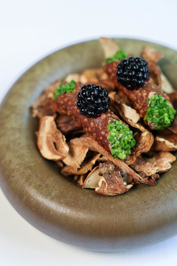 Duck liver parfait and porcini mushroom cannoli, each topped with a blackberry.