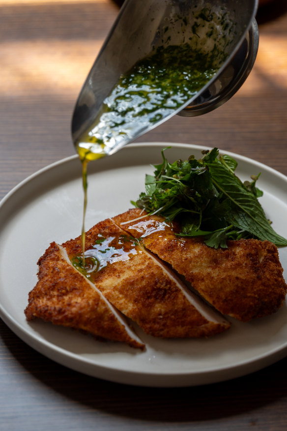 Chicken Kyiv with garlicky, herb-flecked butter.