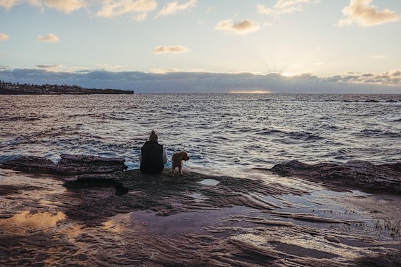People brave the cold at sunrise at the South Coogee cliffs