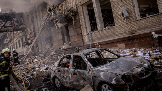 Firefighters work to extinguish a fire at a shopping centre and surrounding buildings after a Russian missile strike in Kharkiv, Ukraine.
