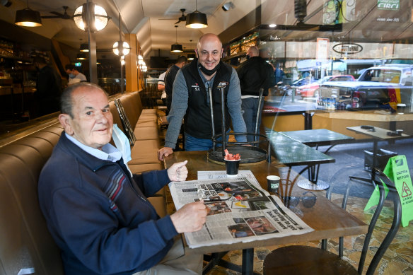 Cafe Notturno owner Salvatore Cultrera  (standing) with his uncle Bruno Cultrera opening after a COVID lockdown in September 2020. 