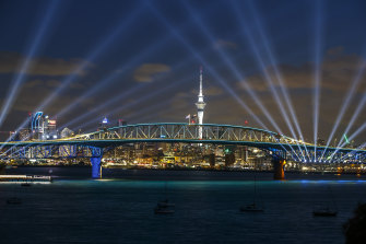 Auckland’s Skytower and harbour bridge lit up as part of NYE celebrations. 