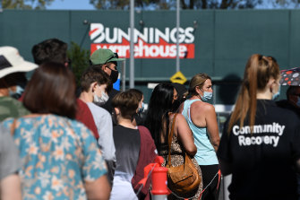 People queue to receive a COVID-19 vaccine at a Bunnings store in Brisbane.
