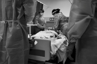 Practising chest compressions on a training dummy called Corey Virus.
