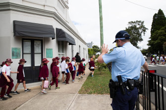 Students from Willoughby Public School return to school on Tuesday afternoon after being evacuated when the adjacent high school received threatening emails.