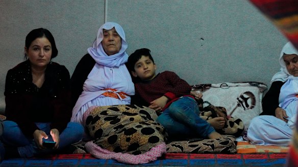 Zena Kalo with her mother-in-law adn family in a tent they share with her sister-in-law in Kabarto camp, northern Iraq, on Friday.
