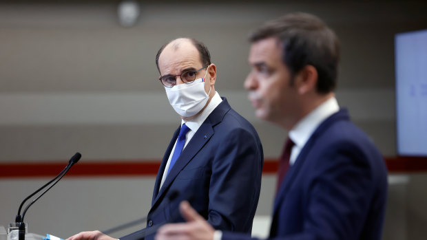 French Prime Minister Jean Castex, left, and French Health Minister Olivier Veran announce the extended national 12-hour curfew.