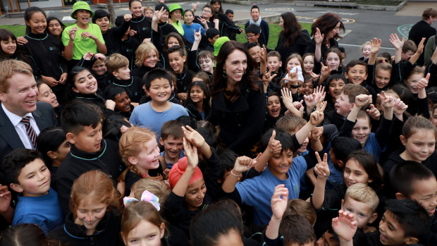 The Prime Minister surrounded by adoring fans in an Auckland schoolyard.
