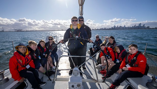 Students at Officer Specialist School. A sailing program to help transform the lives of students from low-socio-economic backgrounds and refugee backgroudns who are living with a disability. Student Rob at the steering wheel.