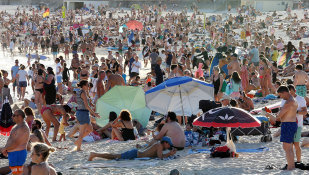 Beachgoers descended on Bondi beach in their thousands on Friday, despite the coronavirus threat.