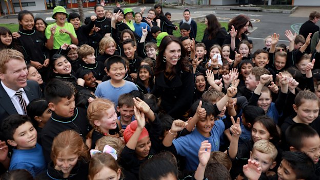 The prime minister surrounded by adoring fans in an Auckland schoolyard.