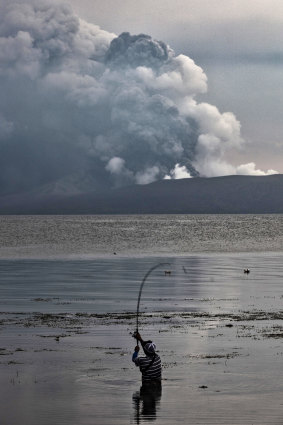 Although tens of thousands have evacuated the area, this resident continued fishing at Lake Taal in the shadow of the volcano.