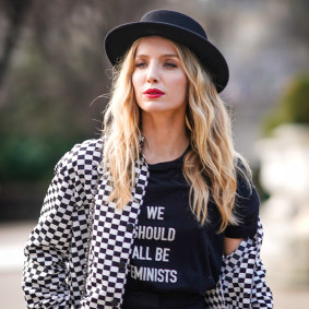 In Paris, a woman embraces Dior's "We should all be feminists" message. 