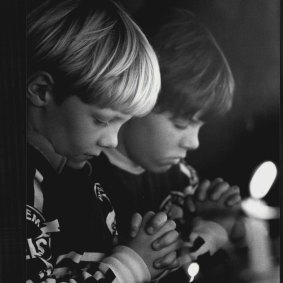 Left to right Brain McCann (6) of Penrith and his brother Hugo (8) pray and light a candle for Pope John Paul 11, May 14, 1981.